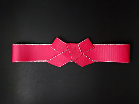 Red Holiday Bow On Dark Background