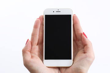 Female hands holding white smartphone