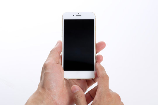 Male hands using white smartphone