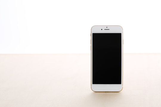 white smart phone on wooden table