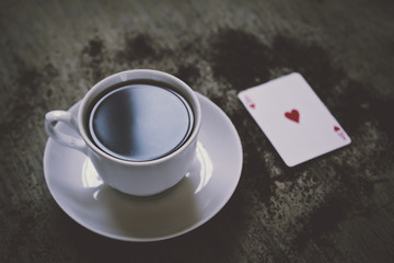 coffee cup and ace of hearts playing cards. luck abstract