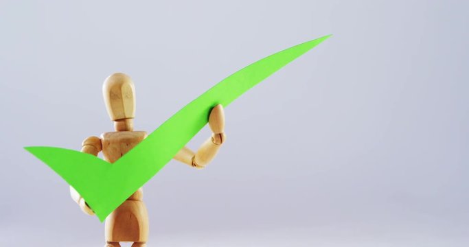 Figurine holding correct sign