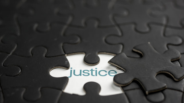 Word justice under jigsaw puzzle piece