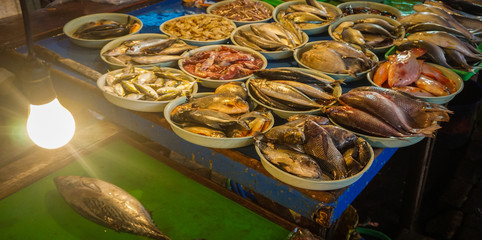 Fresh saltwater fishes displayed on white plastic bucket photo taken in Jakarta Indonesia