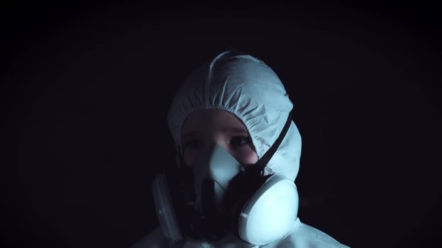 4k Creepy Shot of Child in Respirator Mask and Protective Suit