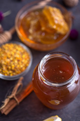 Jar of natural honey on table top view.