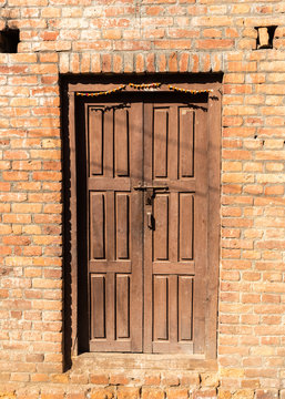 Ancient wooden door in stone wall