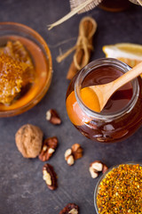 sweet healthy honey in glass jar on the table top view.
