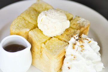 Honey toast with vanilla ice cream , whipped cream and syrup