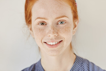 Close up portrait of beautiful young redhead model with different colored eyes and healthy clean...