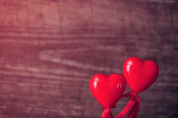 Red heart on the wooden background.