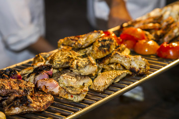 Assorted delicious grilled meat with vegetable over the coals on a barbecue