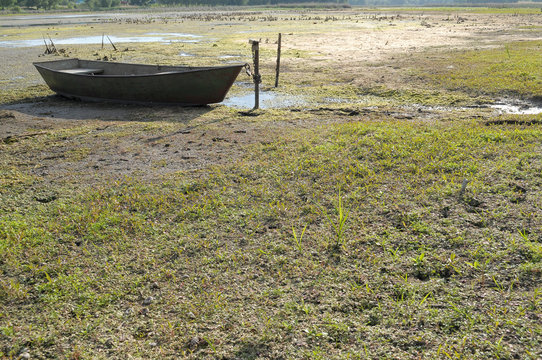 drought in the hot summer. Dried river and rest on land Boat