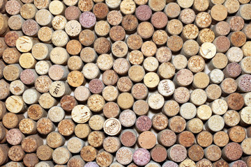Background of used wine corks. Wall of many different wine corks. Closeup of wine corks.