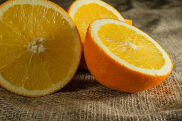 Oranges Fruits and Orange Slice on Wooden Table and Retro Fabric