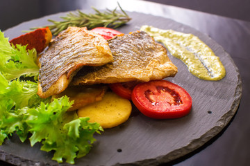 dorado fish with potatoes and tomatoes