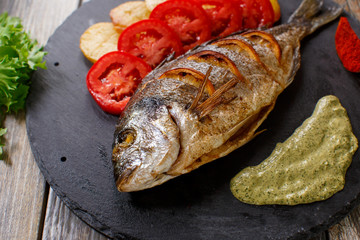 dorado fish with potatoes and tomatoes