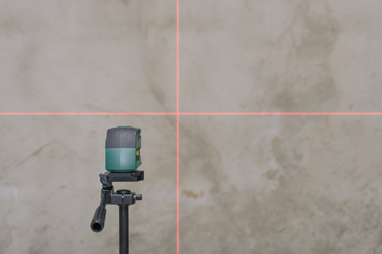 perpendicular to the rays of the laser level on the plastered wa