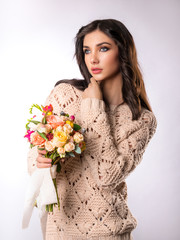 Girl model poses with a bouquet of flowers