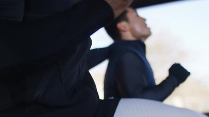 4K Personal trainer and client doing exercise in urban city environment, in slow motion