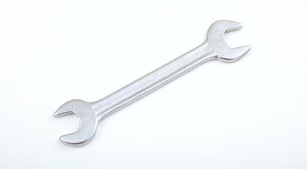 Metal spanner on white background