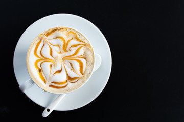 Latte art cup on dark background