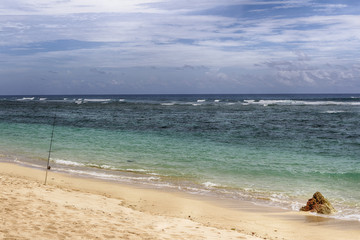 Fishing rod and reel, vacation on blue ocean and summer sky.