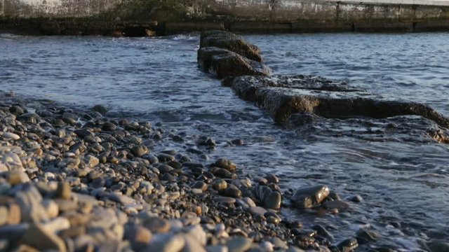 Sea waves lapping on the pebble beach.