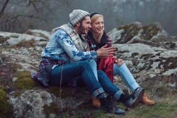 The guy with the girl sit and chat autumn day in nature.