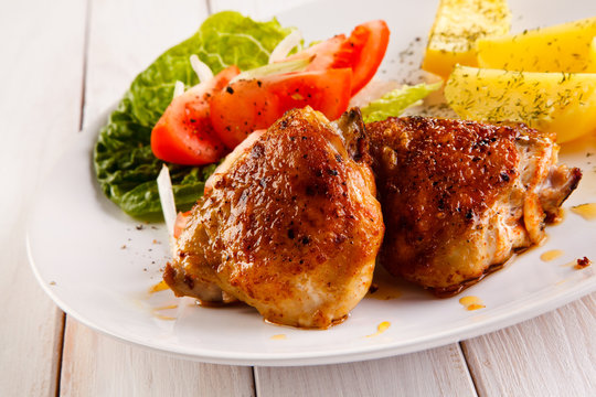 Grilled chicken thighs with boiled potatoes and vegetable salad 