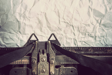 Vintage typewriter and crumpled paper. Focus on ribbon.