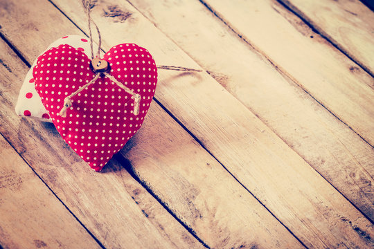 Fabric heart on wooden background with space for text