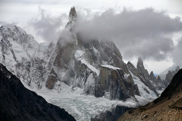 Pointed top with glacier in clouds. The top of Cerro Torre. Patagonia. Argentina.