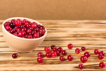 Cranberry. Cranberries on glay Plate Wooden Background