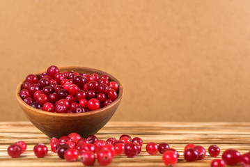 Cranberry. Cranberries on glay Plate Wooden Background
