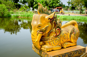 Thai deity elephant on the background of the lake in the Park.