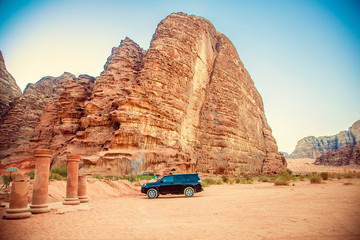 Black jeep car in the desert near the mountains in Petra, Wadi Rum. Jordan