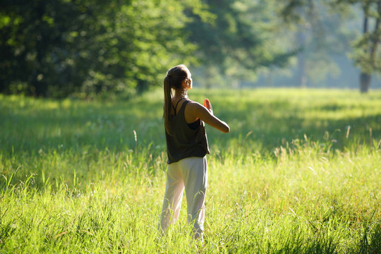 Woman standing in forest with praying hands of yoga - Powered by Adobe