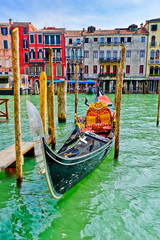 Fototapeta na wymiar Gondolas moored on the Grand Canal in Venice, Italy.