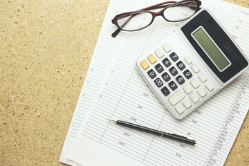 calculator,glasses and pen on documents