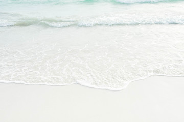 Fototapeta na wymiar Soft wave of blue and green ocean/sea on sandy beach. Background.