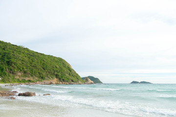 the green big mountain with sea sand sun and the beach on sunshine day and bright sky and cloud background.