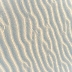 Closeup of sand pattern of a beach in the summer. Beach background. Top view