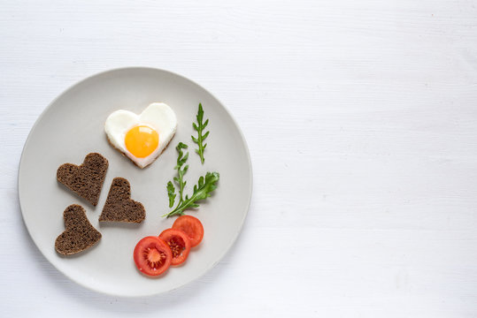 Heart shaped eggs and bread. St. Valentine's Day breakfast