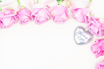 Valentines day violet roses buds top view flat lay scene with heart and copy space