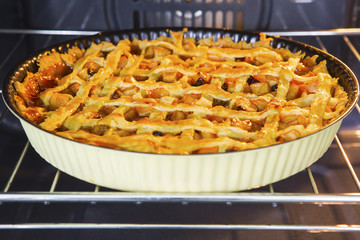 Homemade apple pie baked inside oven