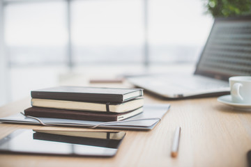 Documents on office table with pen and digital tablet as work space business concept.