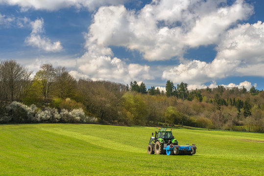 Ein Traktor fährt im grünen Feld