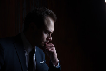 Portrait of a businessman on black background
