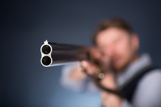 Office worker holding a shotgun